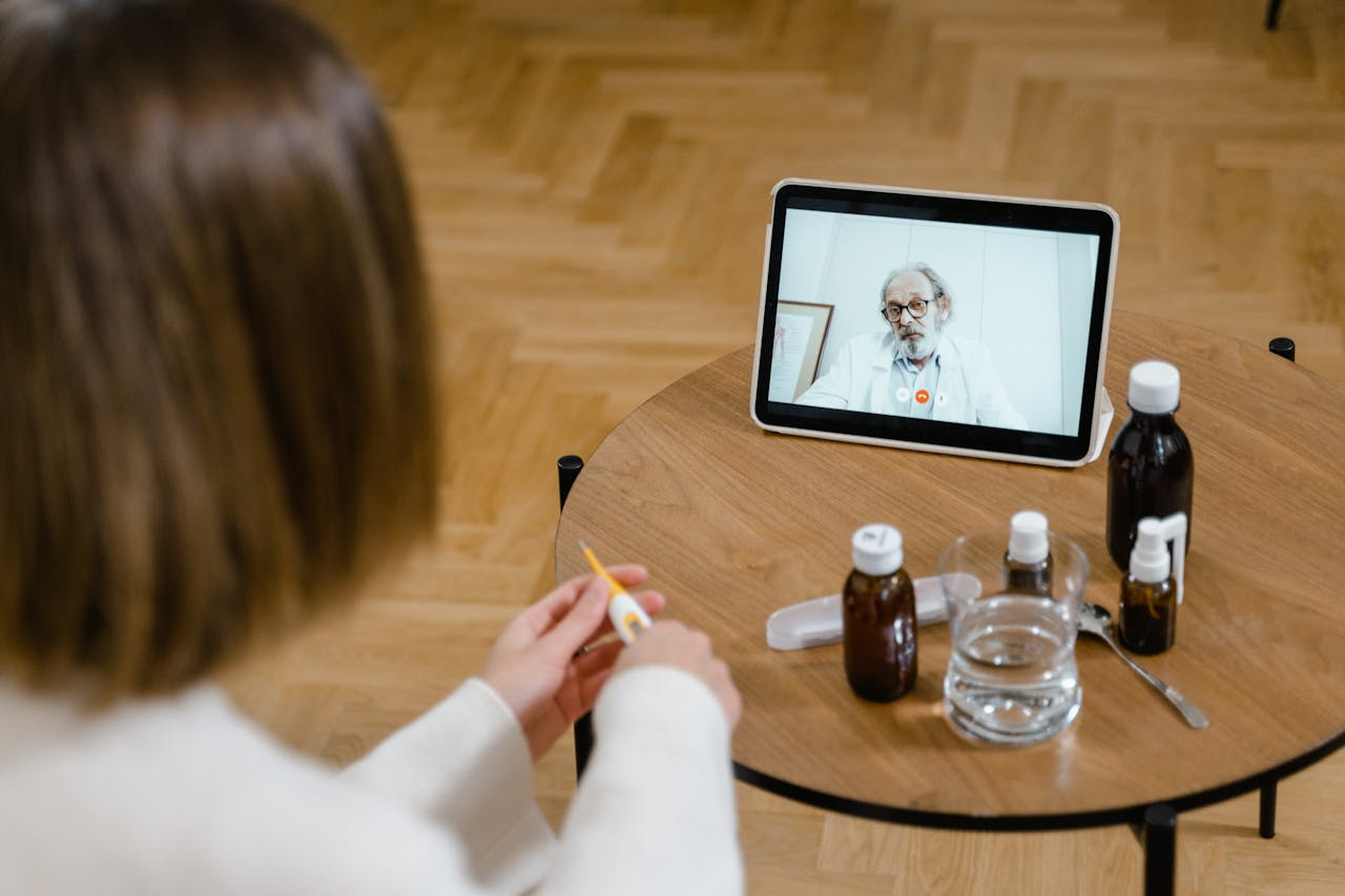why-choose-us A doctor provides an online consultation via video call on a tablet, seen on a wooden table.